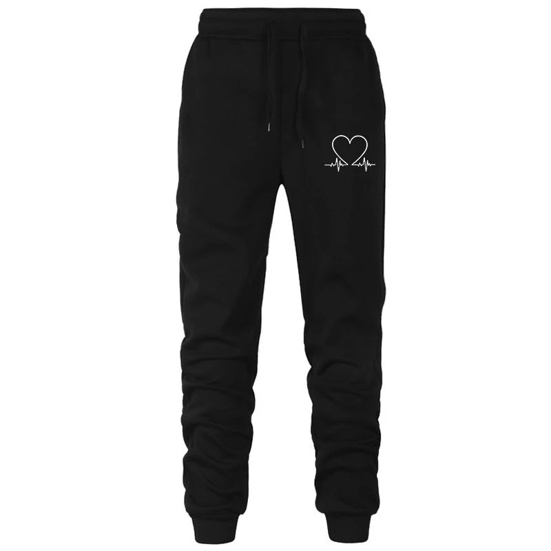 Black sweatpants with a heart and heartbeat design on a white background