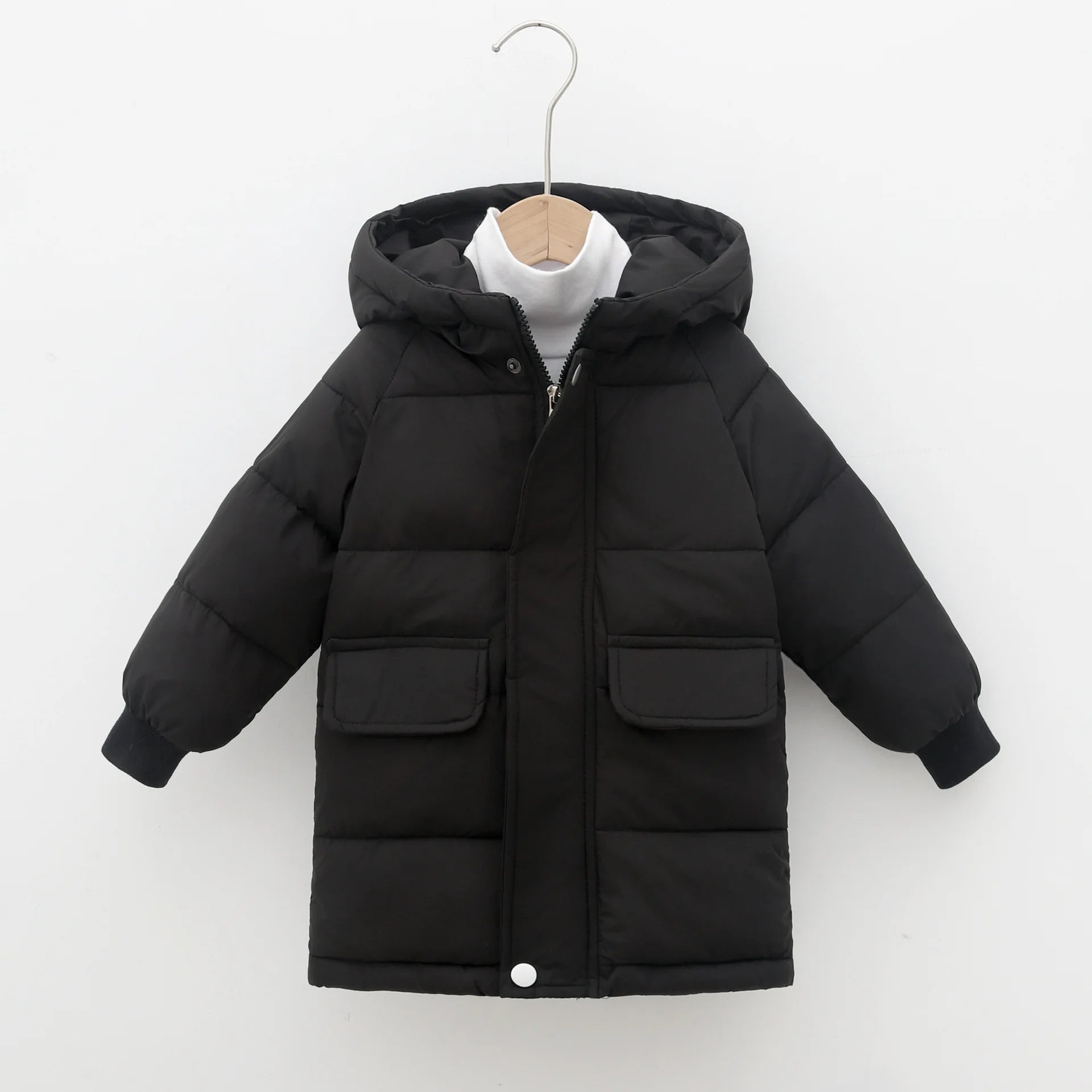 Black puffer jacket on a hanger against a white background