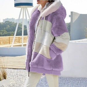 Person wearing a colorful faux fur coat with a blurred outdoor background